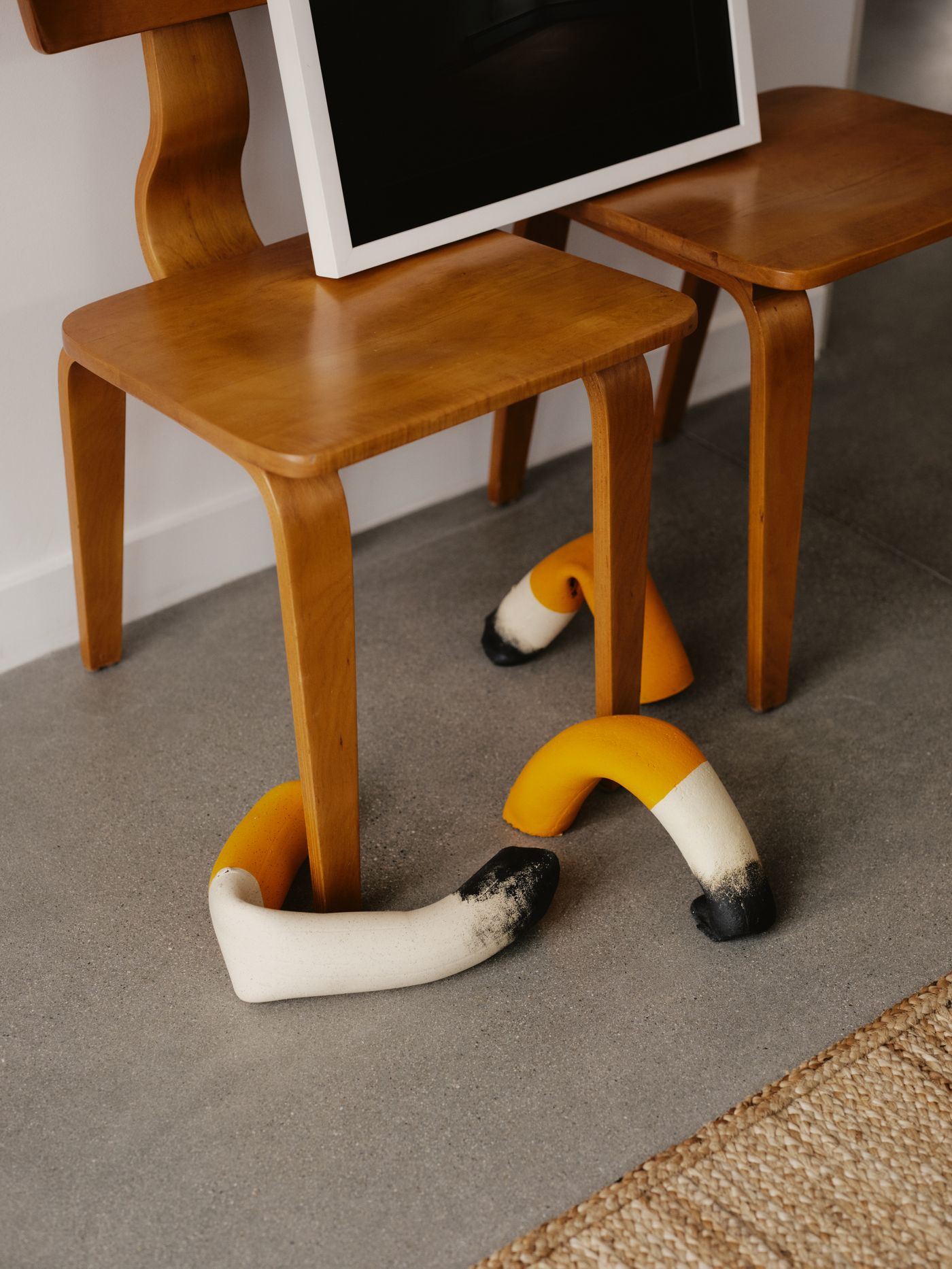 Sculptural wood chairs and a yellow sculpture