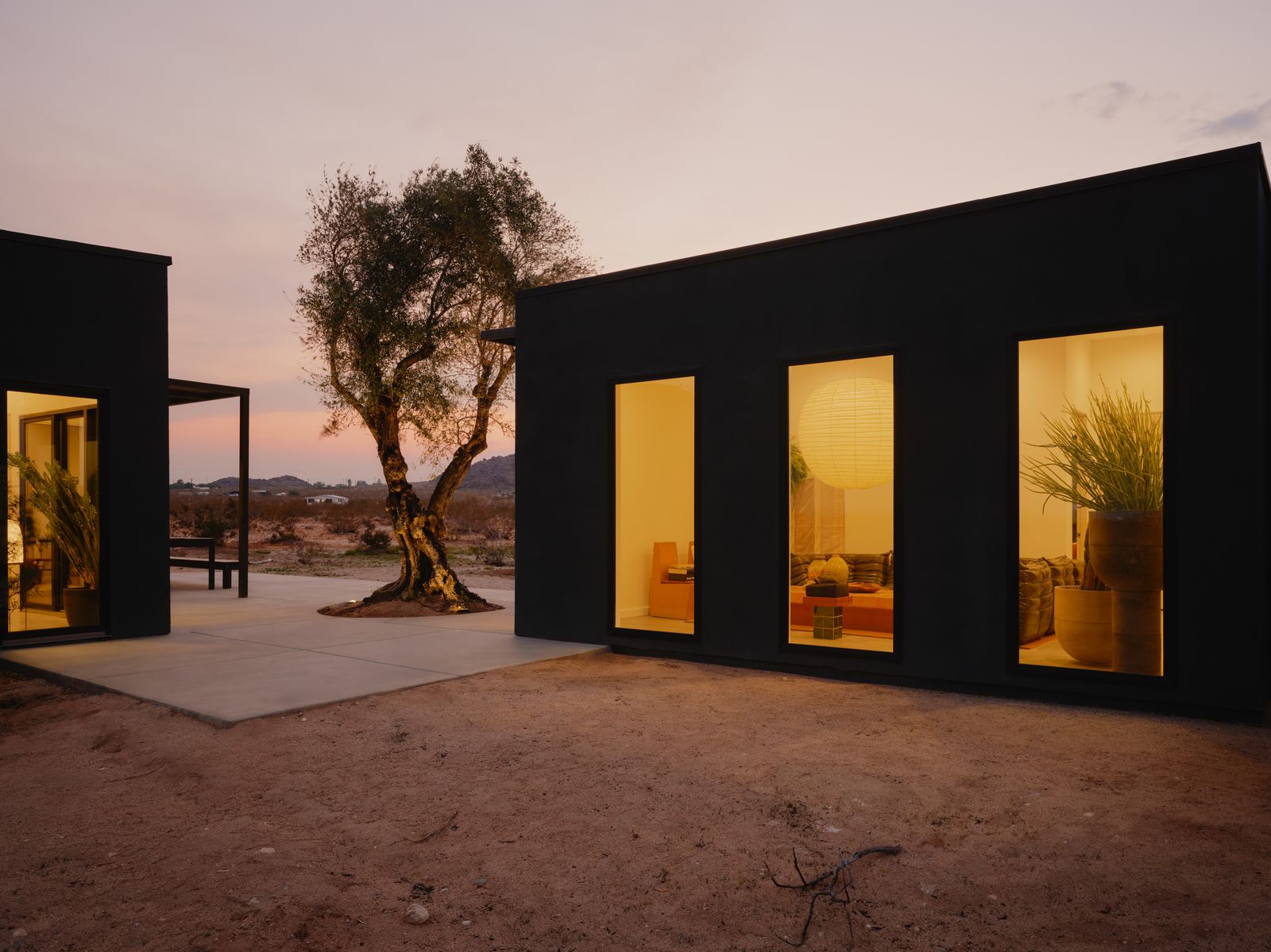 Amber windows across the dark facade