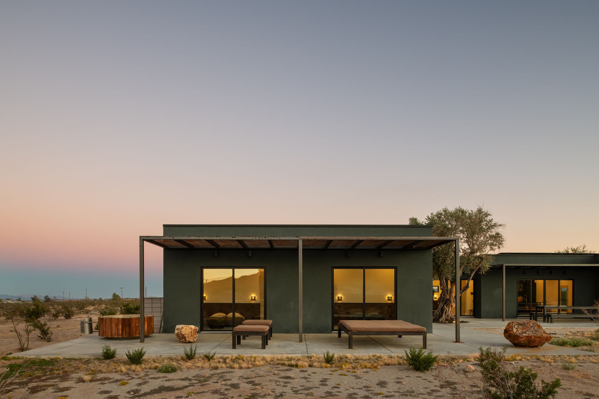 The compound at dusk under a pastel sky