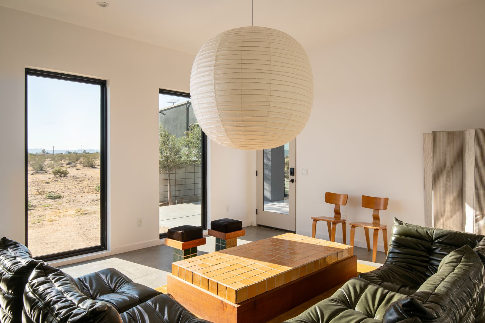 Living room with paper lantern and green leather sofa