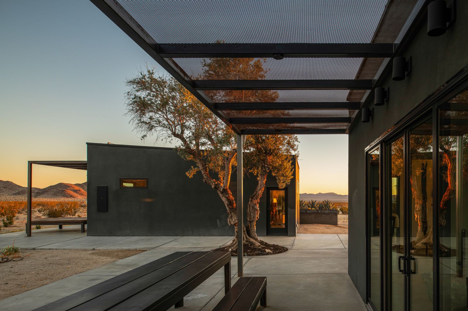 The covered patio and long table under the pergola